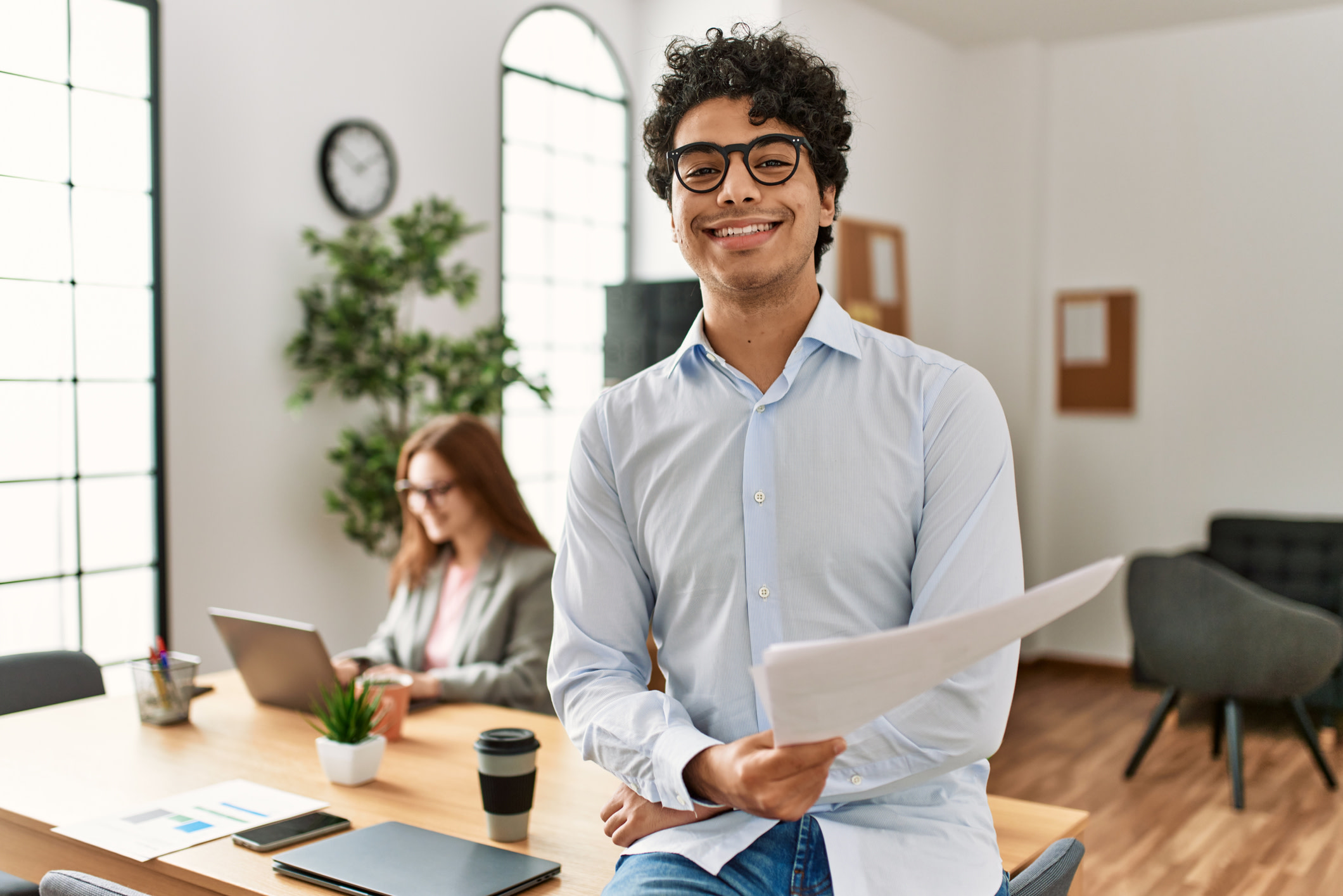 Business manager smiling happy and confident. Employee working at the office.

