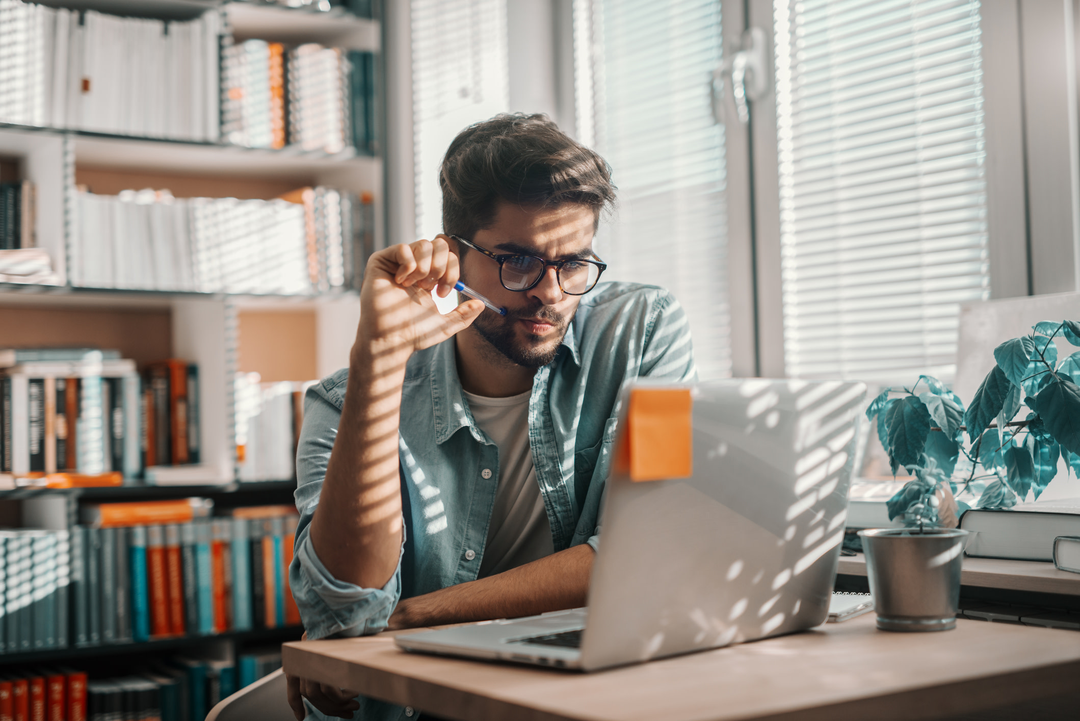 A man thinking in front of a computer.