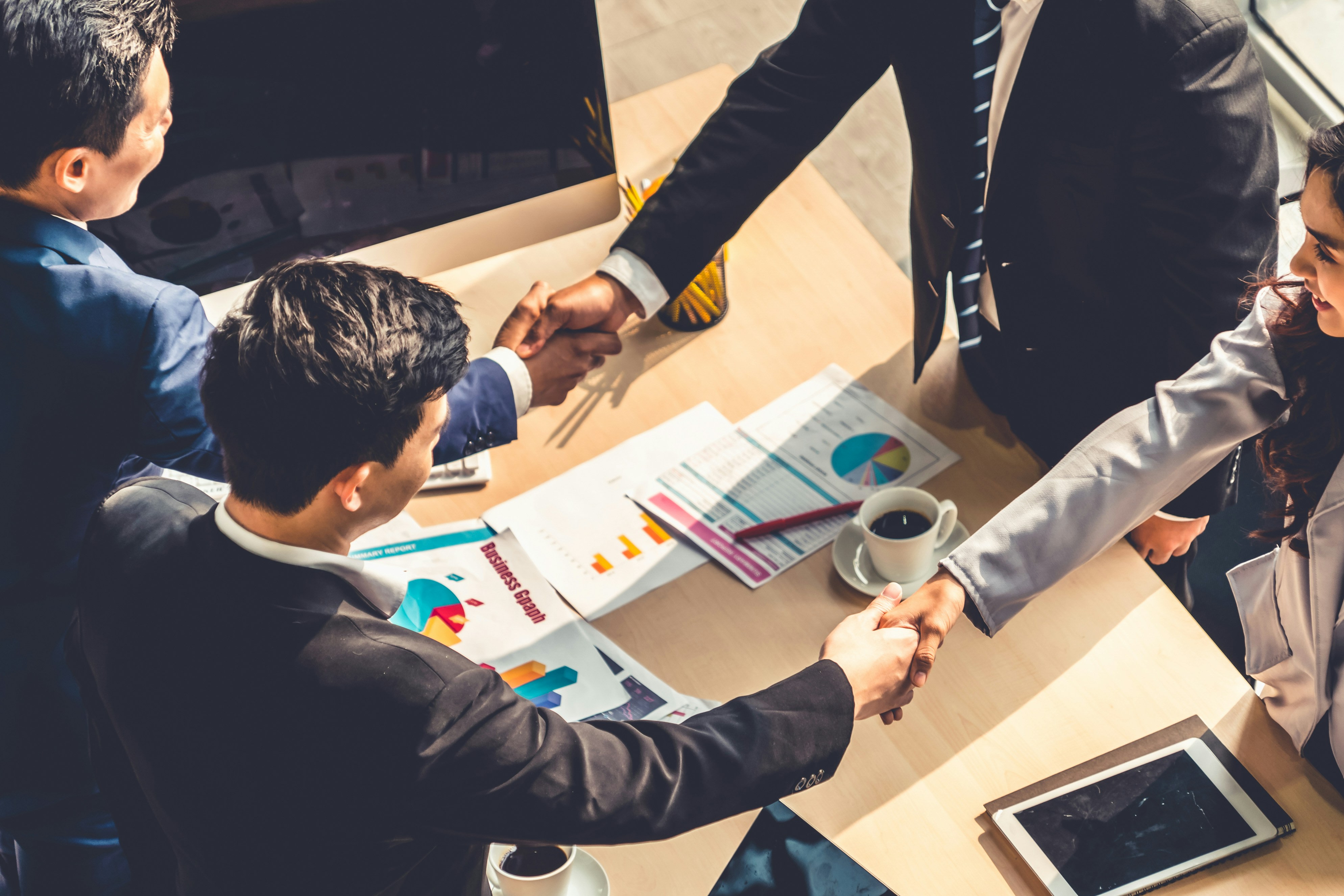 Men shake hands at a business meeting