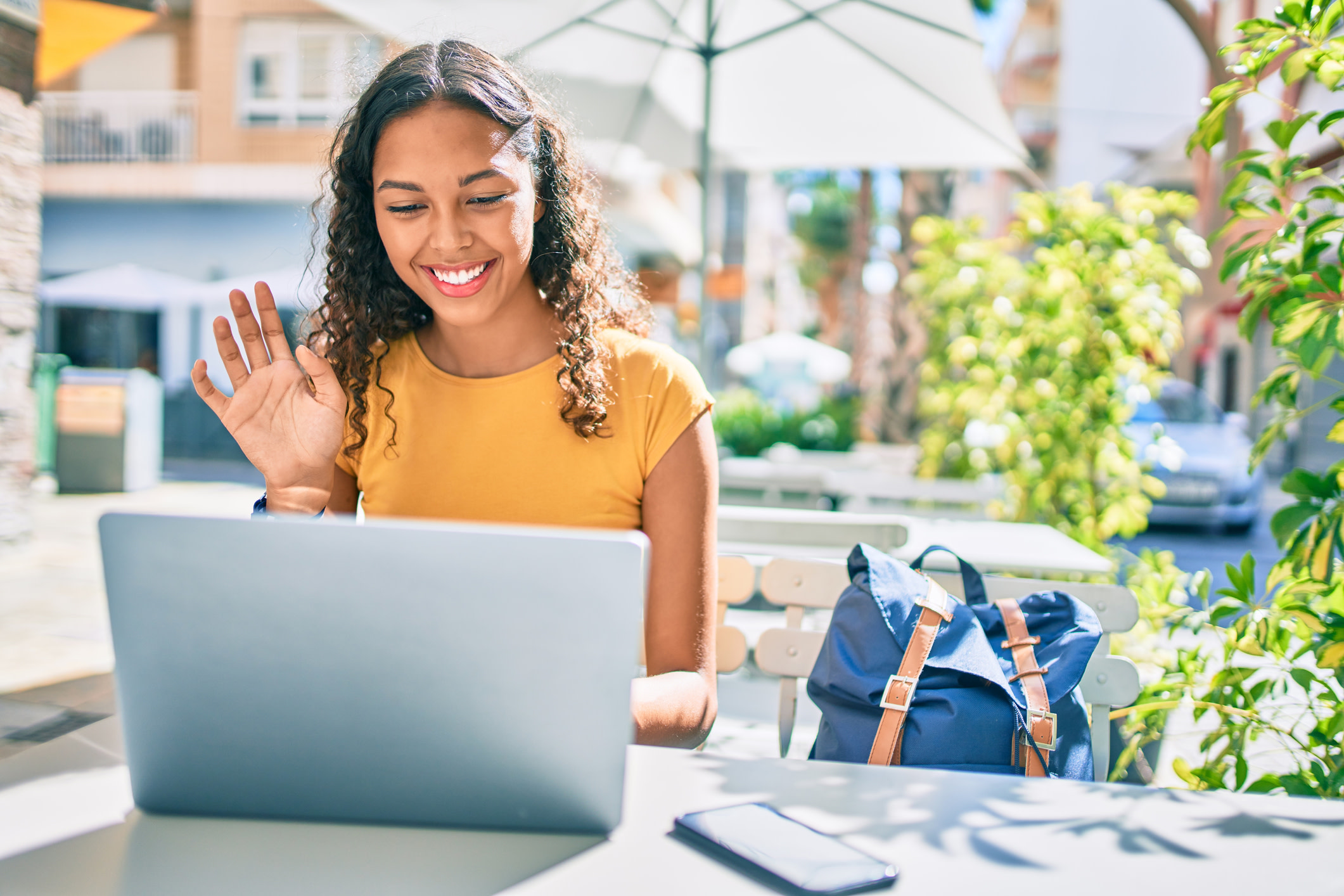 Young african american student girl doing video call using laptop.

