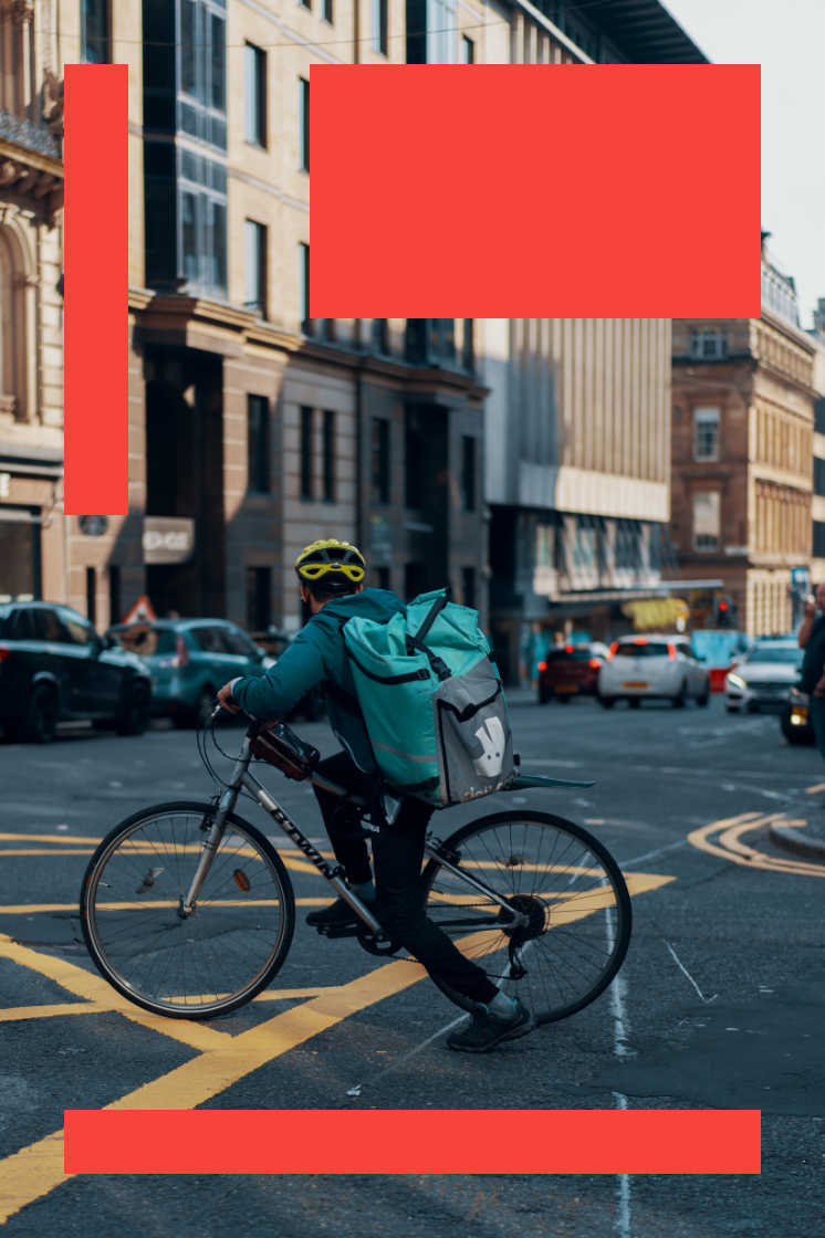 A Deliveroo rider sets off at a junction