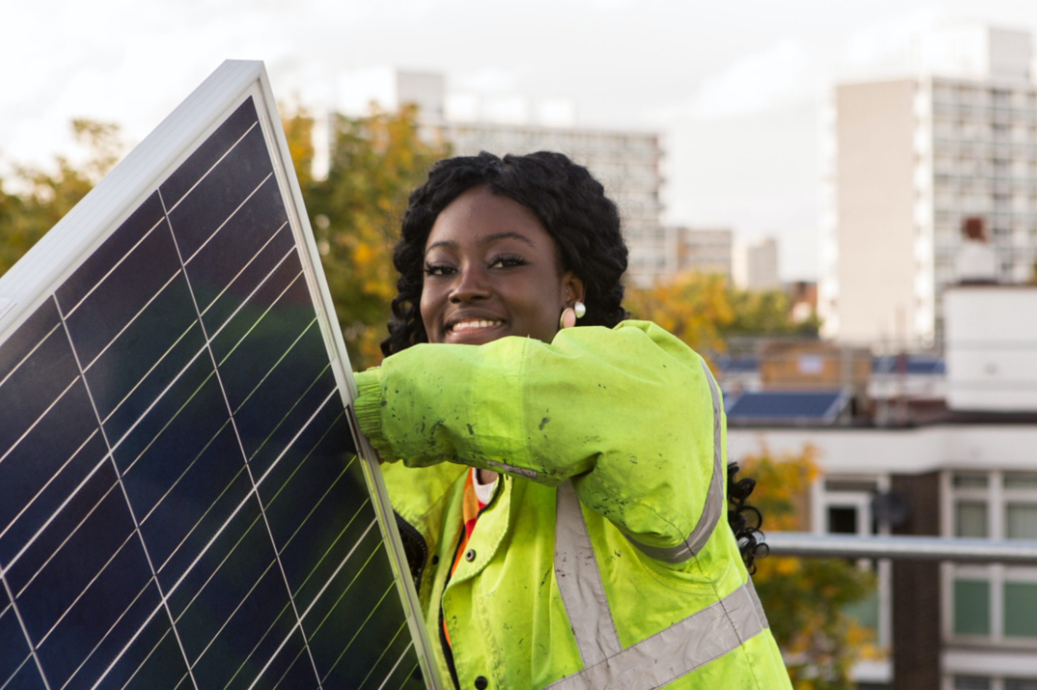 Woman in hi-viz jacket installing solar panel