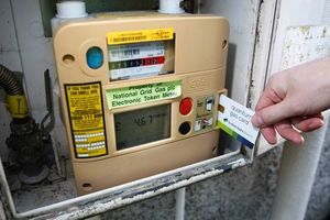 Person using an electronic gas token meter.