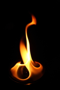 A flame with a dark background. 