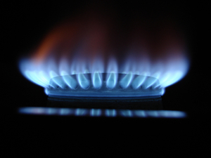A gas stove with its flame on.