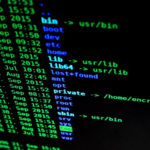 Image of black computer screen with greena and blue typed code.
