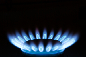 A gas stove with its flame on.