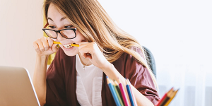 woman looking frustrated and biting pen after her energy suppleir goes bust