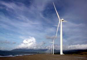 A row of wind turbines on a wind farm.