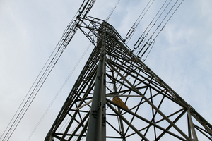 Image looking up at an electricity pylon.