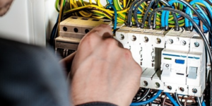 Image of engineer wiring up an energy meter.
