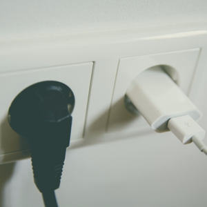 Image of a black plug in socket and a white plugs in socket. 
