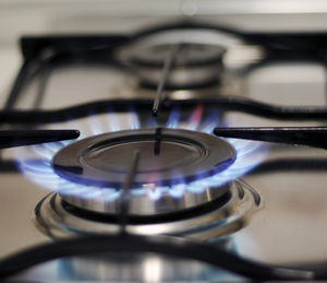 Image of stove top with the flame on.