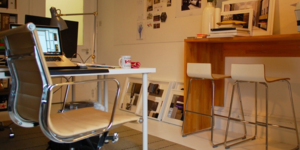 Image of a home office. Chair, desk, and laptop in the background. 