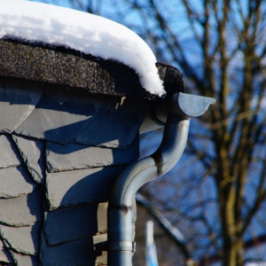 Image of a roof gutter with snow.