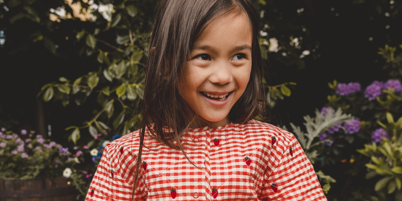 Girl wearing Floss jacket with strawberry embroidery