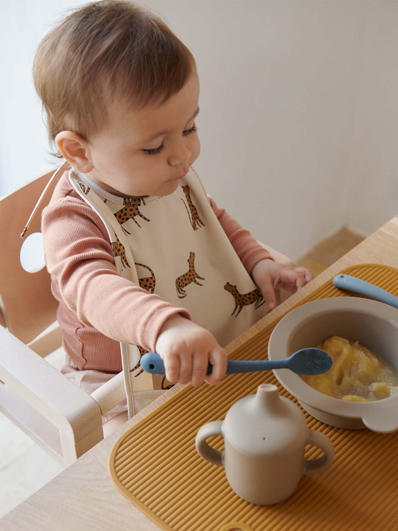 baby eating with liewood utensils