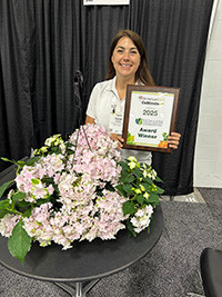 Woman holding the award for Haba Hydrangea