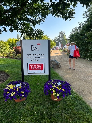 Flower pots in front of an outdoor welcome sign