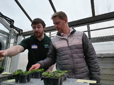 Nathan Jahnke is on the right and an MSU presenter is on the left. They're pointing at pack growth trials.