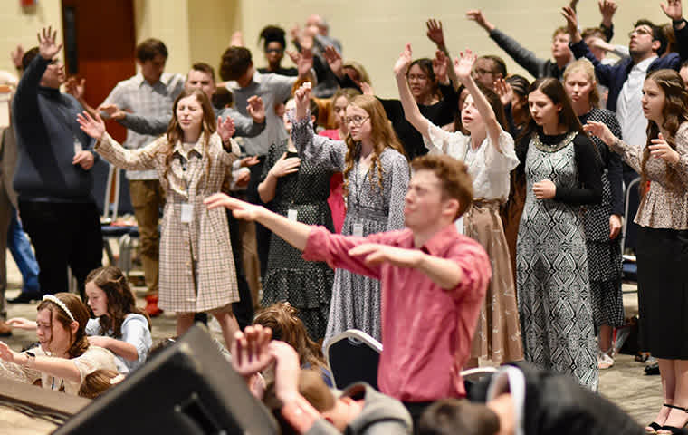 youth praying at an altar