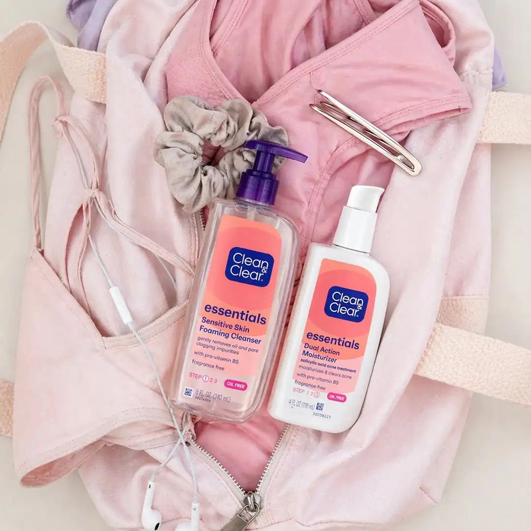 Clean & Clear® Essentials products on top of women’s gym clothes