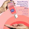A hand is holding a bottle of Clean & Clear Essentials® Foaming Sensitive Skin Facial Cleanser and squeezing some of the product into the palm