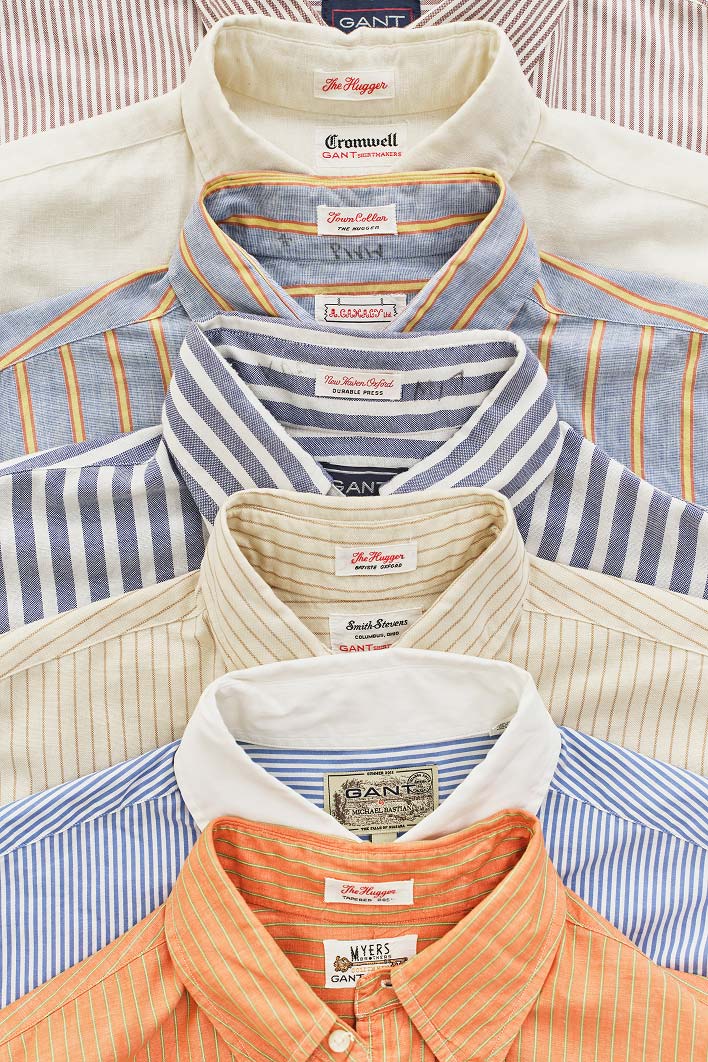 Pila di camicie vintage Gant a righe con bottoni disposte in fila.