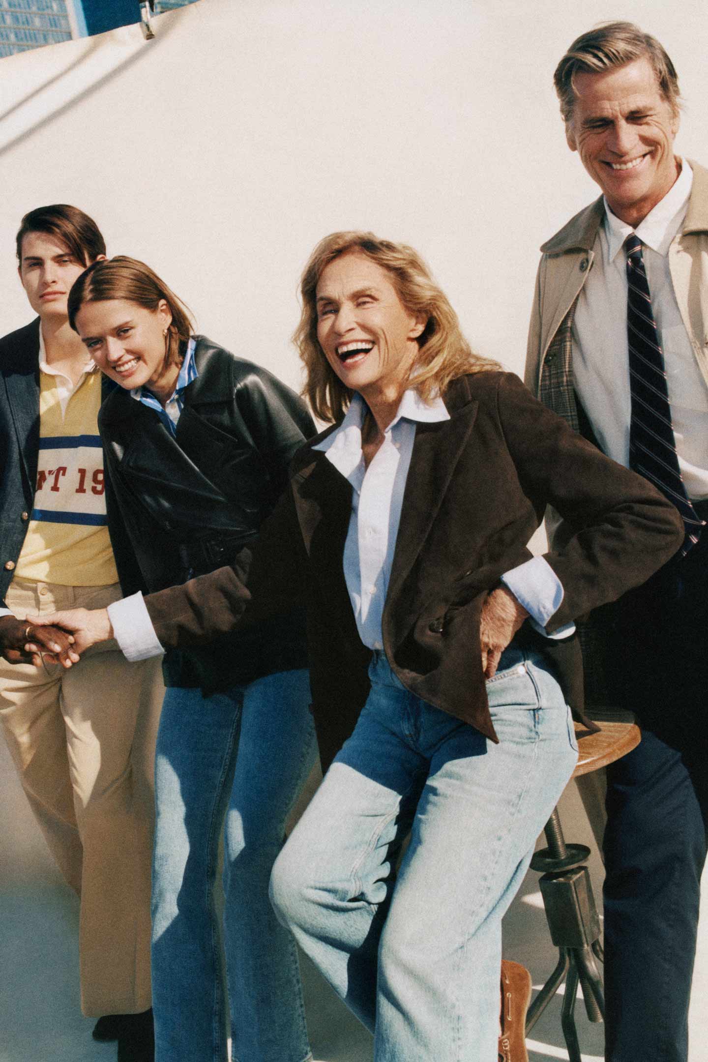 Group wearing Gant suits, jackets and outerwear interacting on a rooftop set with tall city buildings in the background