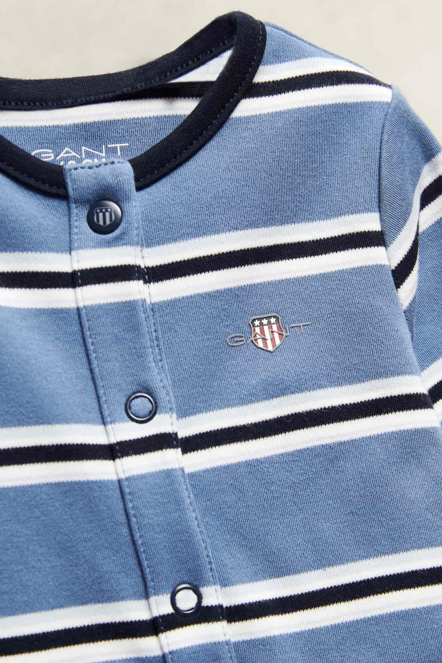 Gant striped baby bodysuit in light blue with snap-button fastening and embroidered shield logo.