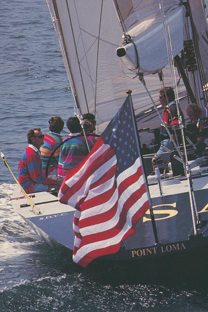 Gruppo che naviga su una barca indossando colorate maglie da rugby Gant.