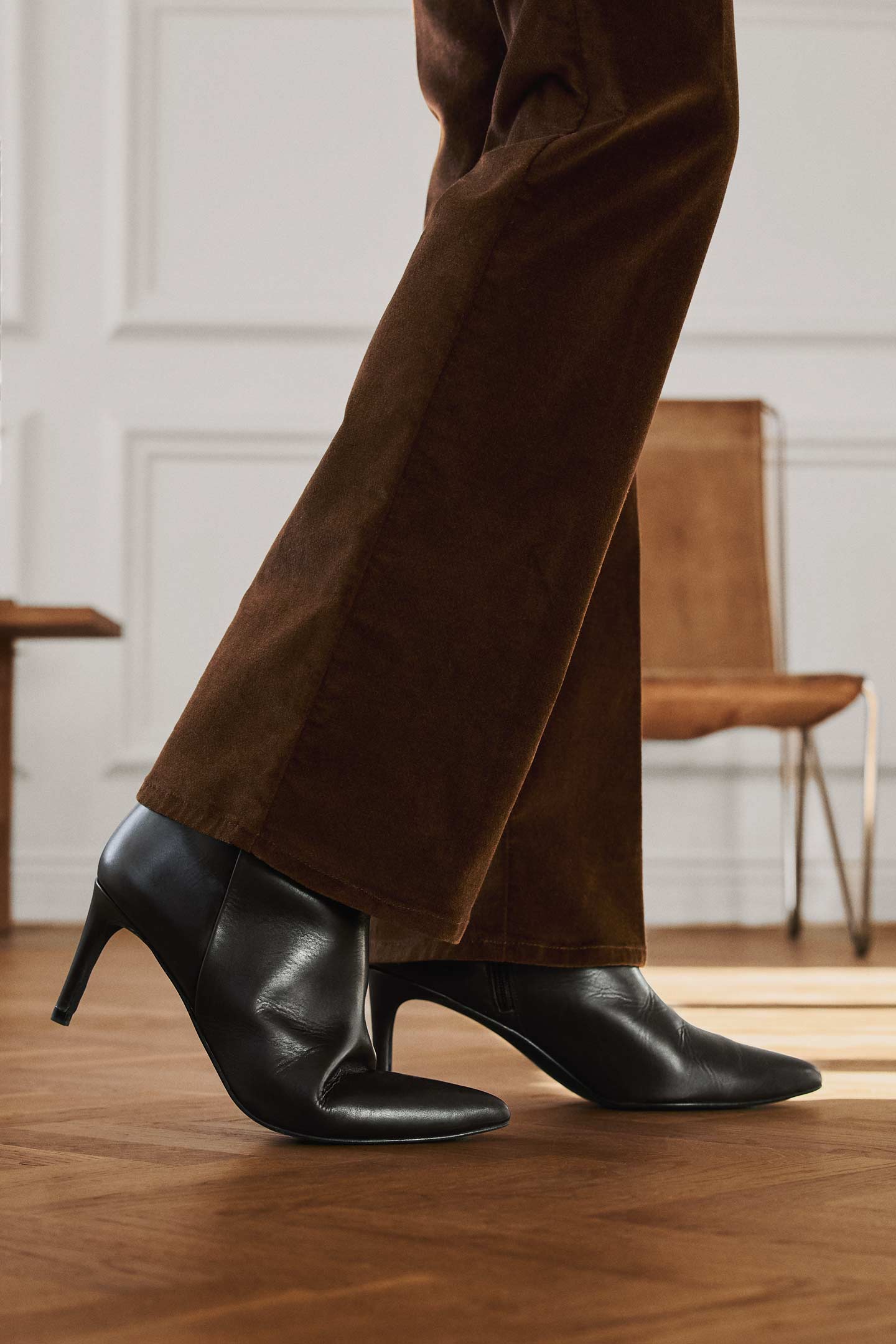 Gant leather high healed boots paired with tailored trousers, shown in a close-up footwear detail.