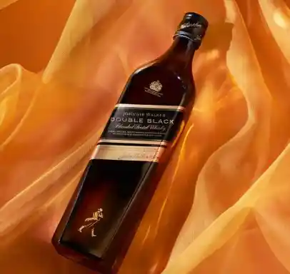 Bottle of Johnnie Walker on a yellow silk sheet