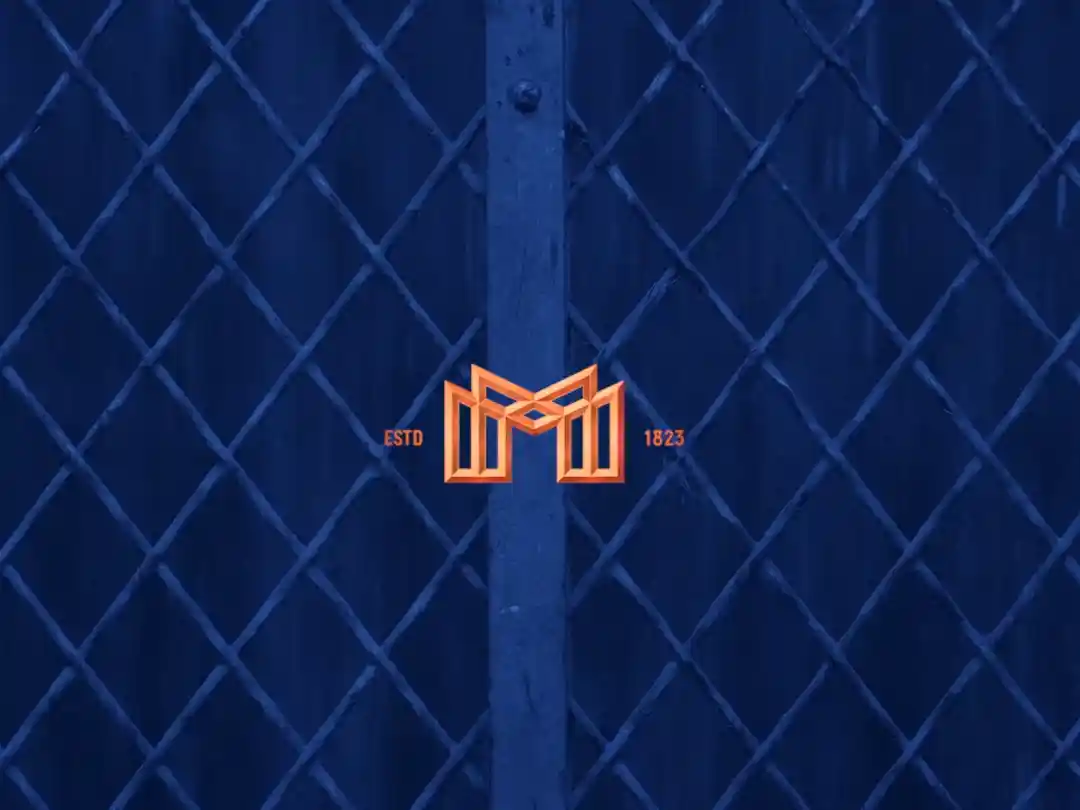 Mortlach logo on a filed of blue with a fence in the background