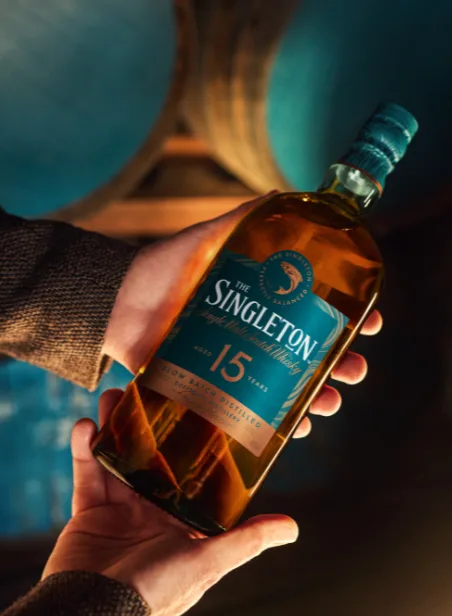 Hands holding a bottle of The Singleton 15