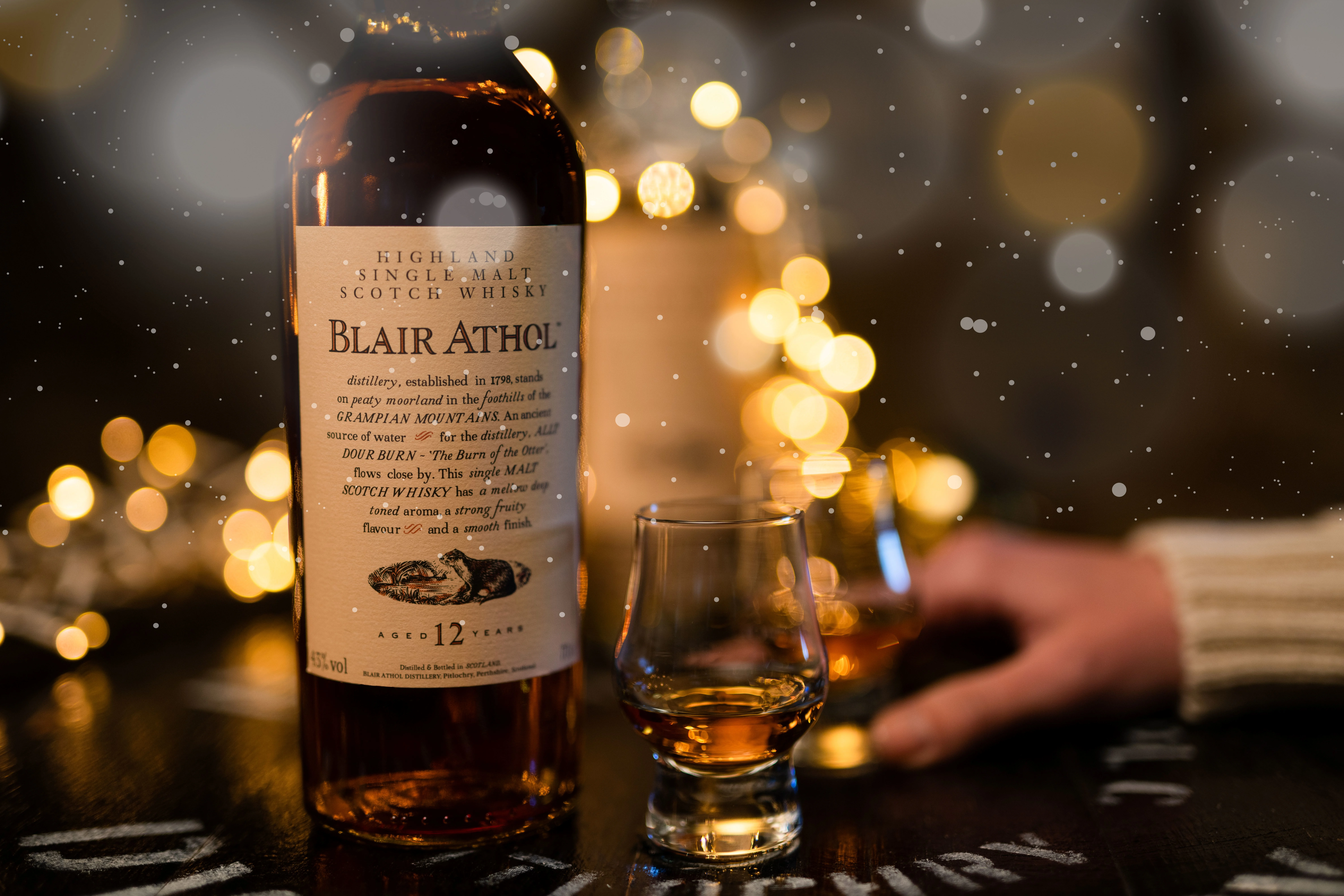 Bottle of Blair Athol Whisky, and two small glasses of whisky during Christmas 