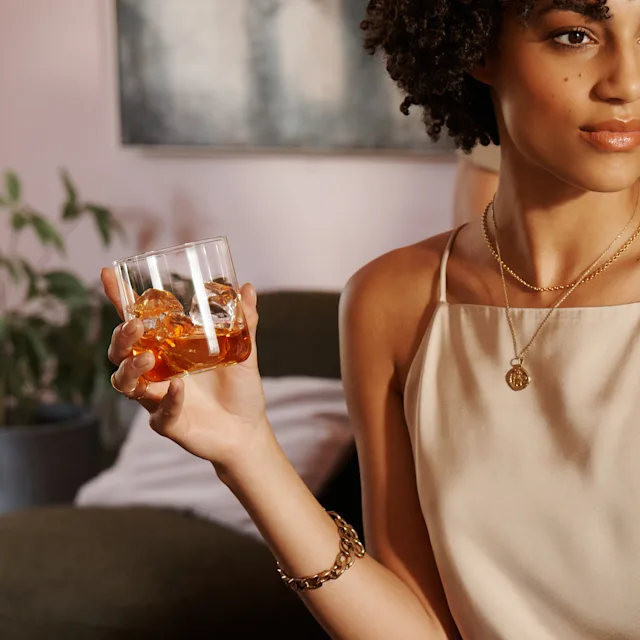 Woman holding a whisky cocktail