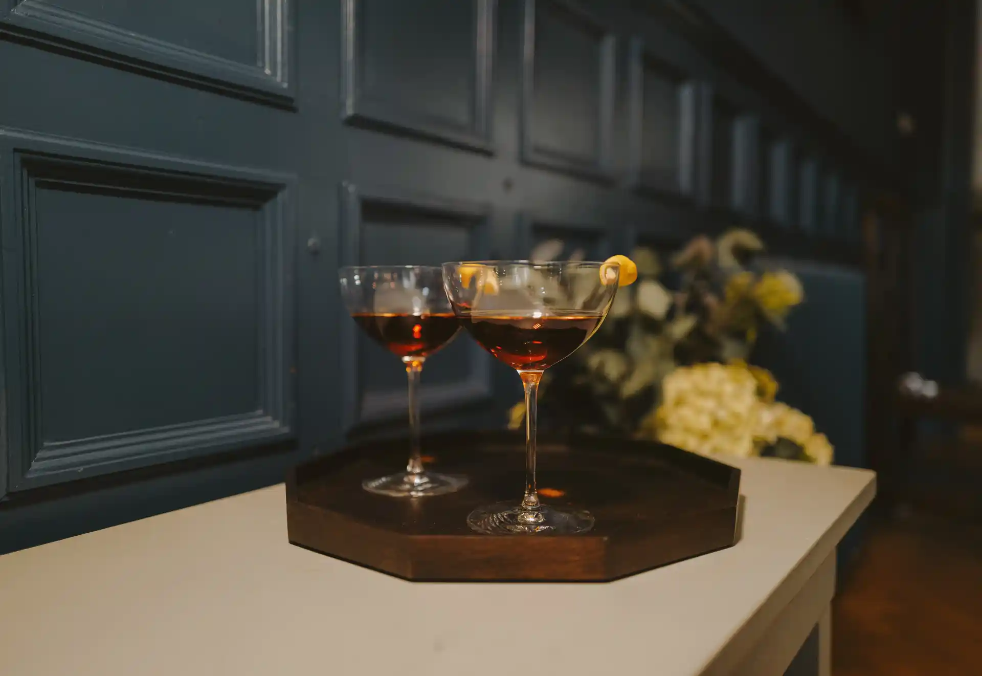 Two Manhattan cocktails on a tray