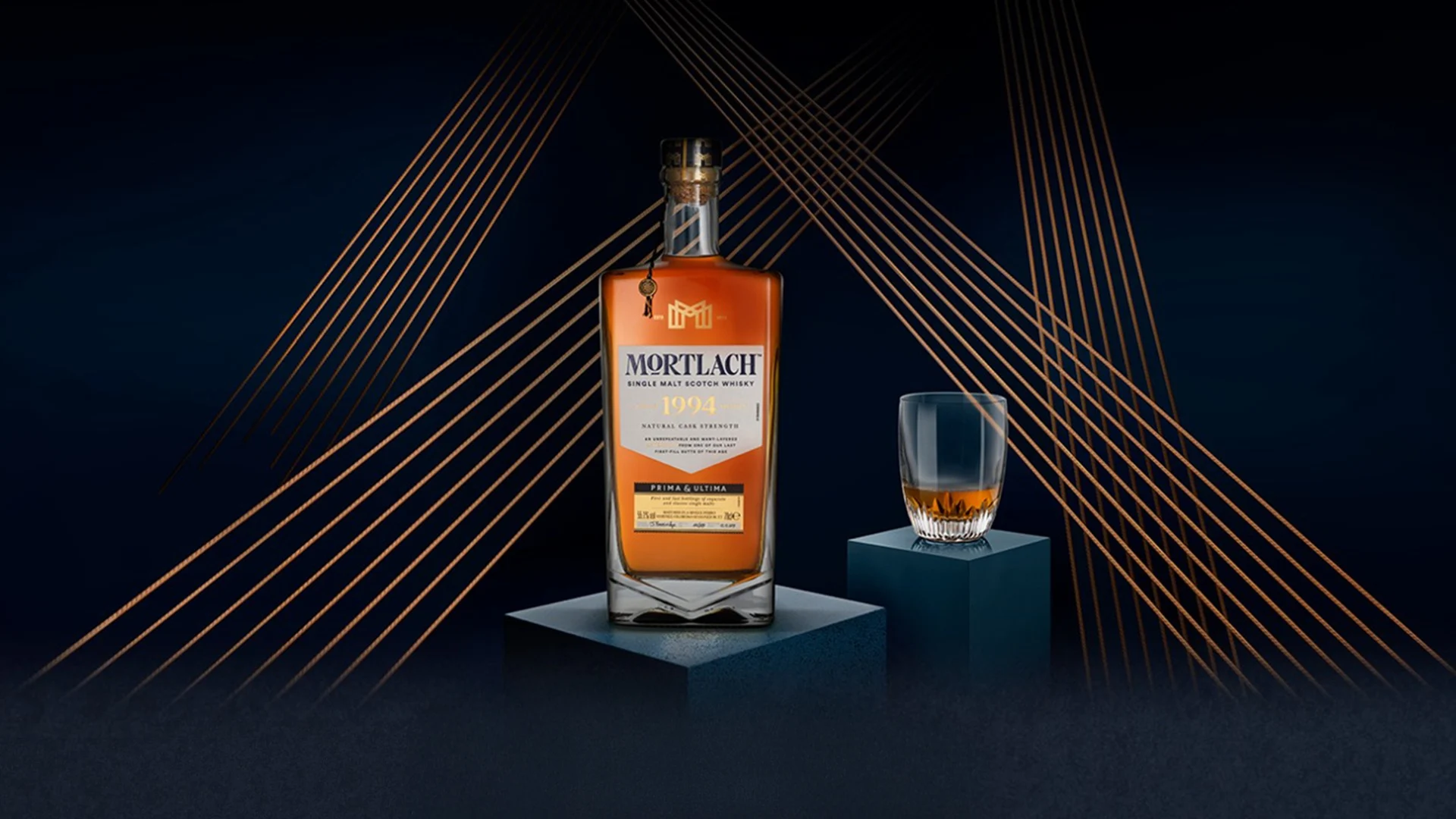 A bottle on Mortlach 1994 Single Malt Scotch Whisky sits on a plinth with a dram of whisky next to it on a separate plinth.