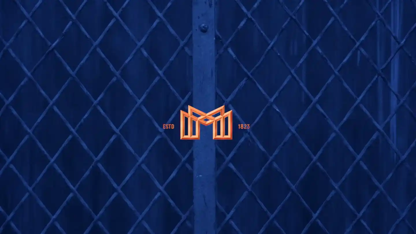 Mortlach logo on a filed of blue with a fence in the background