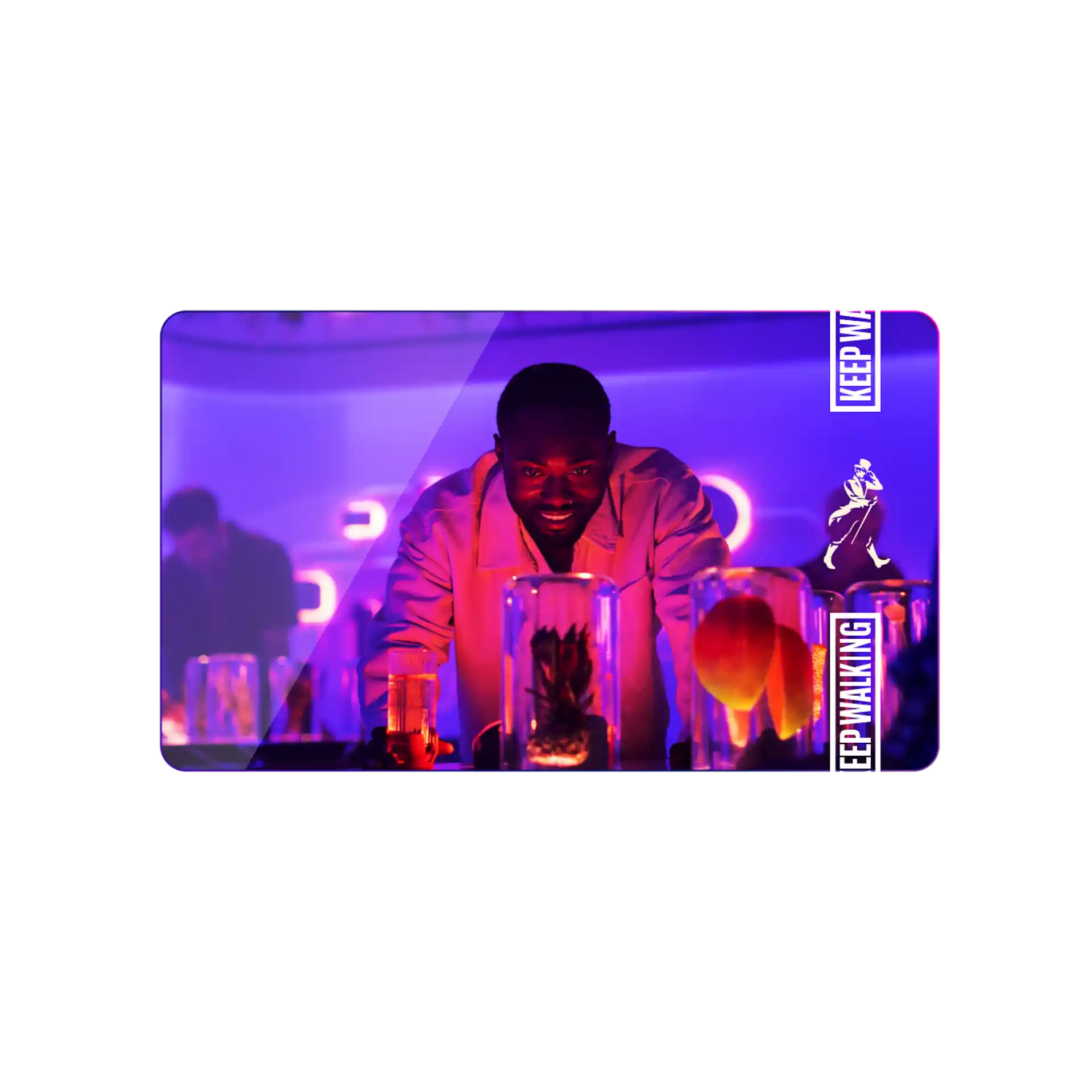 A man in a neon lit room intrigued whilst observing bottles holding ingredients whilst experience the tour. 