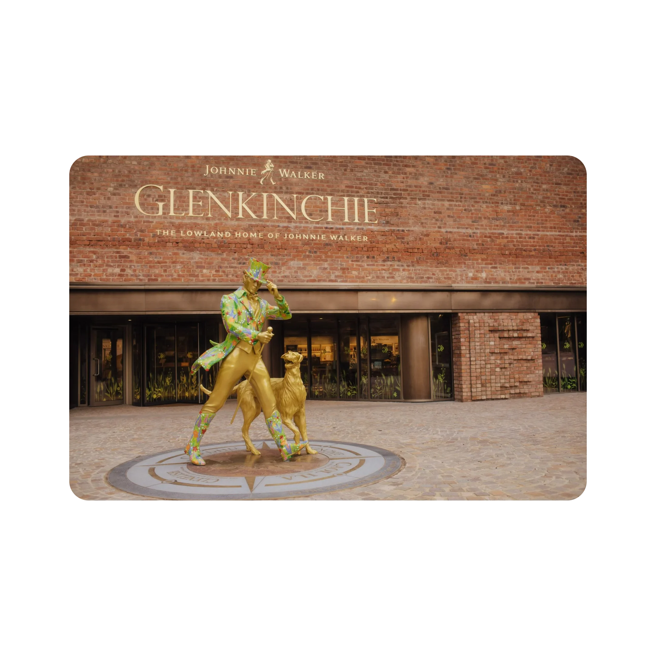 A statue of the unique striding man and Bruce the dog outside the glorious entrance to the Glenkinchie distillery.