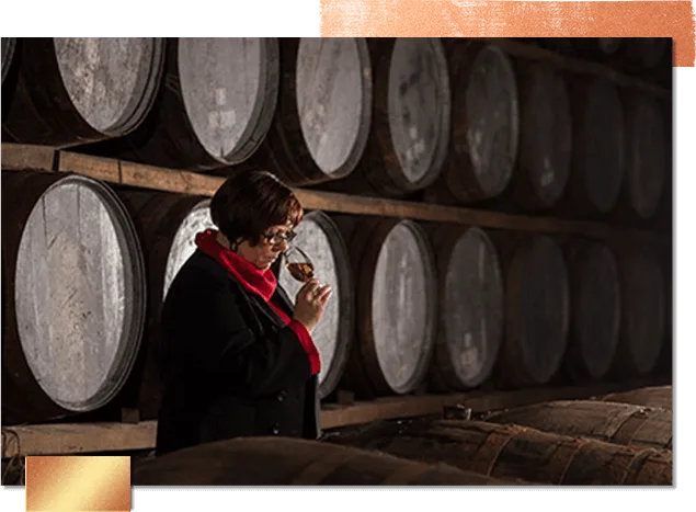 莫琳-罗宾逊(Maureen Robinson)站在格伦奥德酒厂的木桶旁