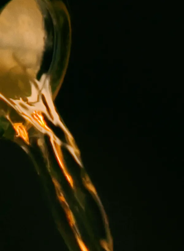 Lagavulin Grain & Embers whisky being poured from bottle