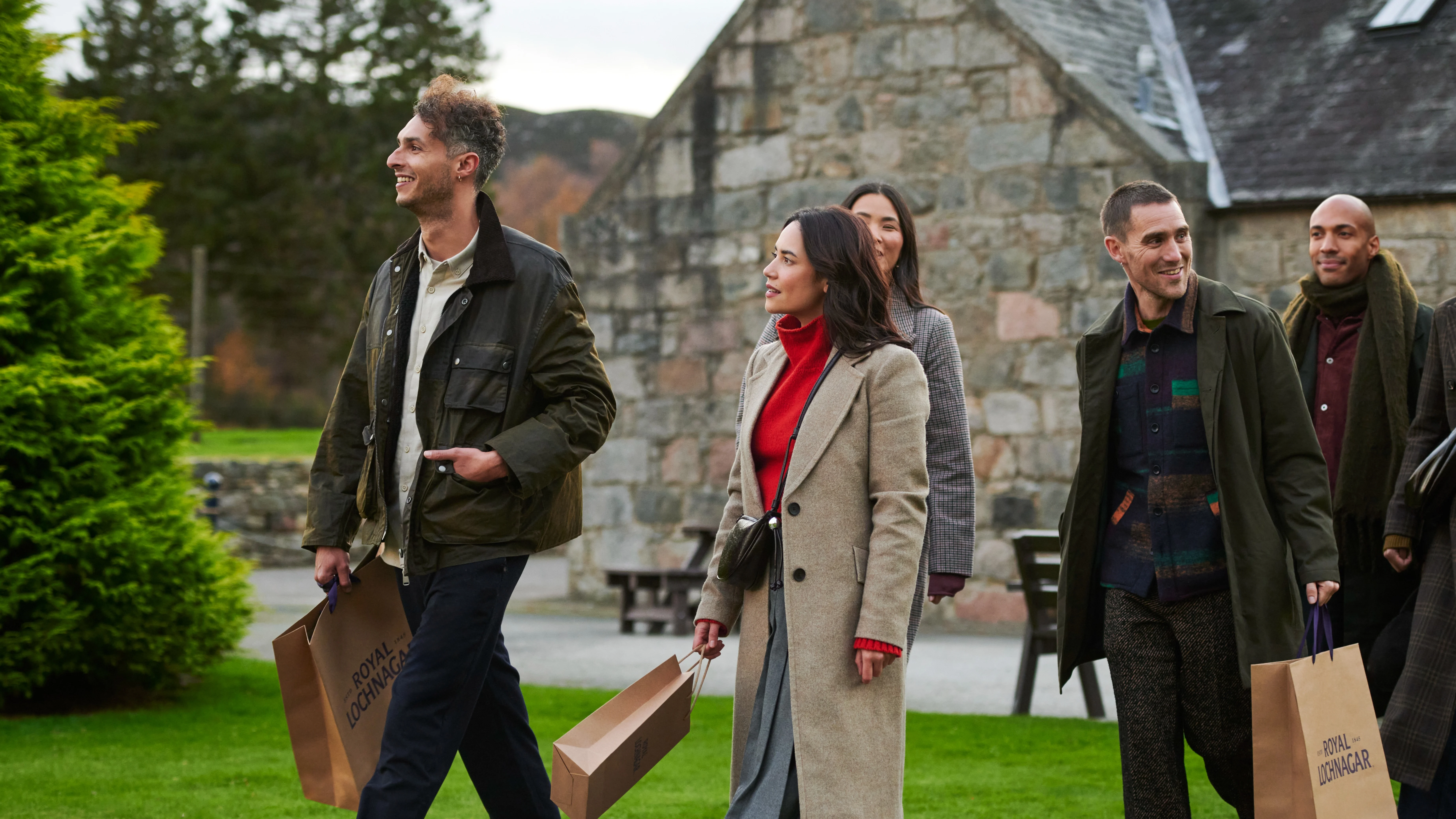 Friends leaving Royal Lochnagar distillery with gift bags