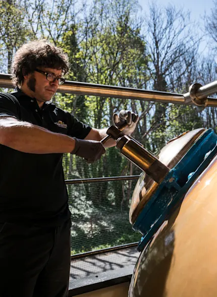A man performing an action on a whisky distillery