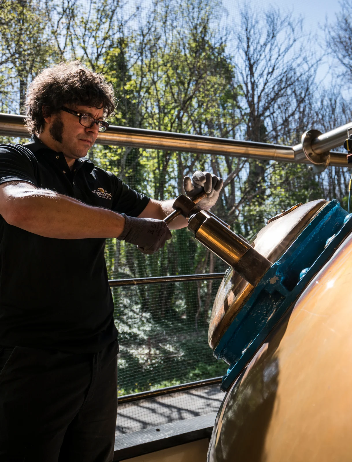 A man performing an action on a whisky distillery