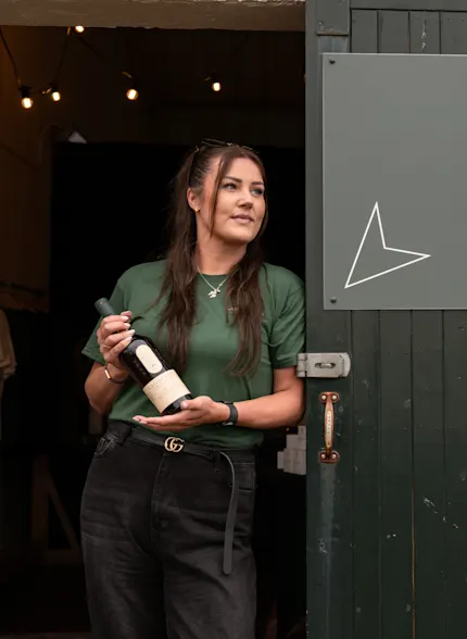Kirsten Robertson, Lagavulin’s first female Senior Operator, leaning against the doorway of the distillery