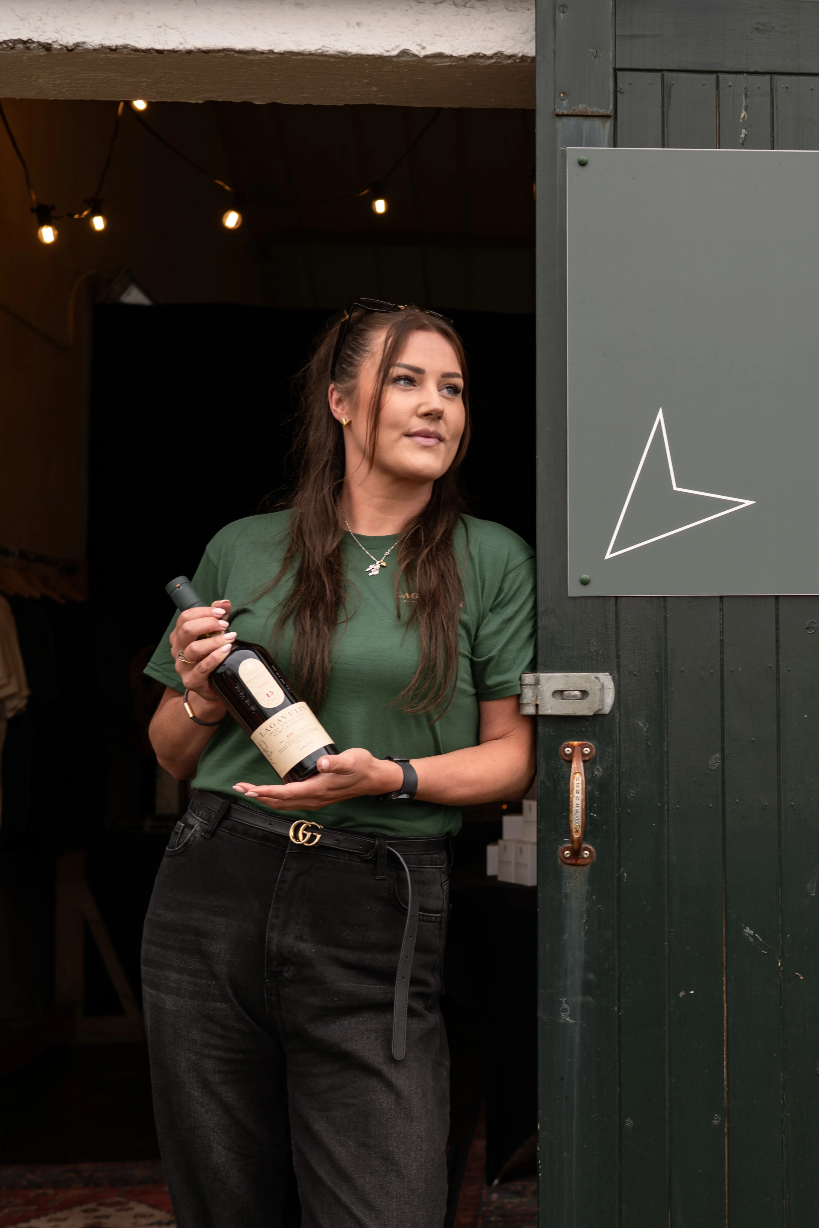 Kirsten Robertson, Lagavulin’s first female Senior Operator, leaning against the doorway of the distillery