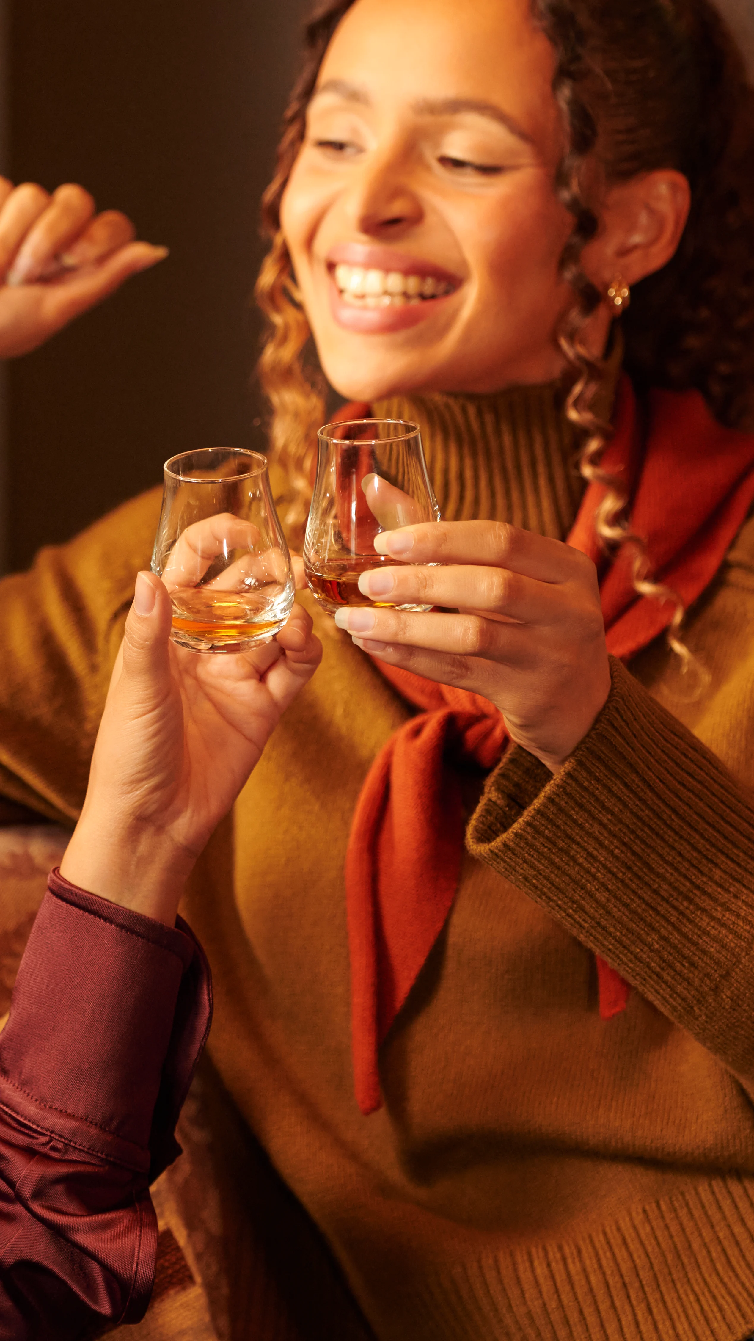 Two women toasting whisky 